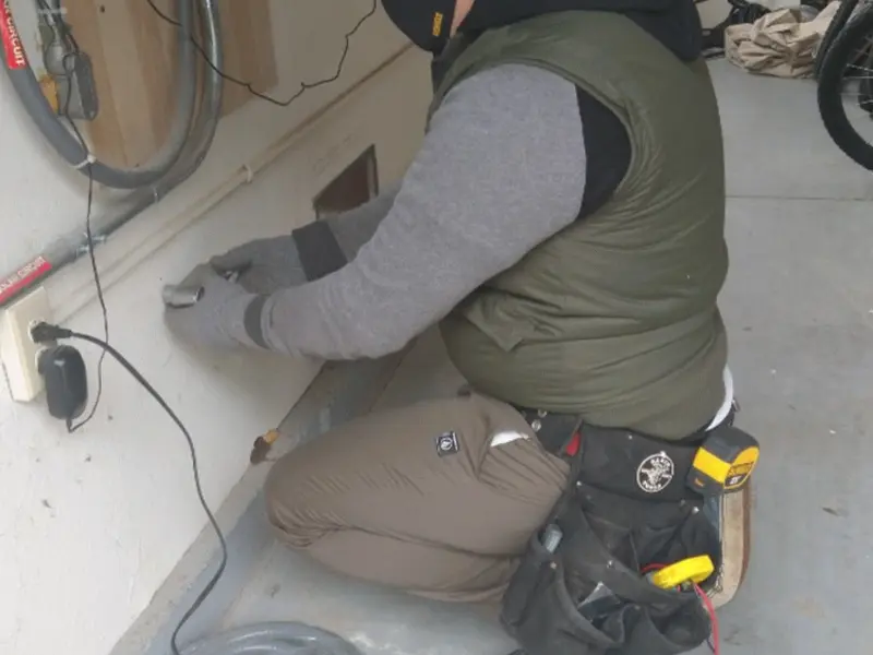 Electrician performing outlet wiring in a Cypress Lake garage